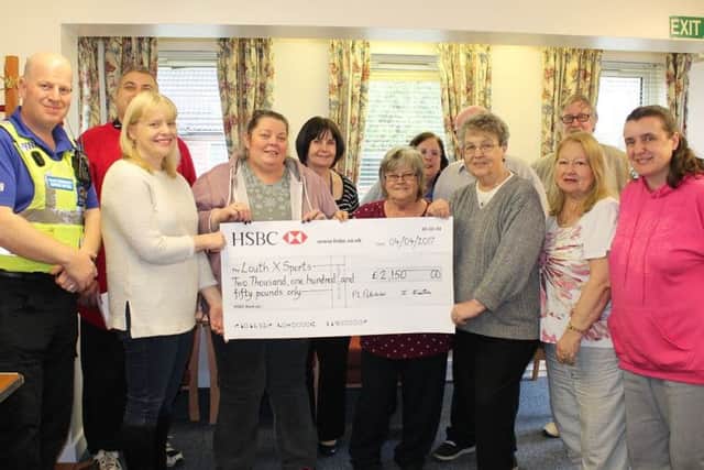 Beech Grove Residents' Association presents the cheque to Yvonne Andrews and Sarah Dodds from LouthXSports.