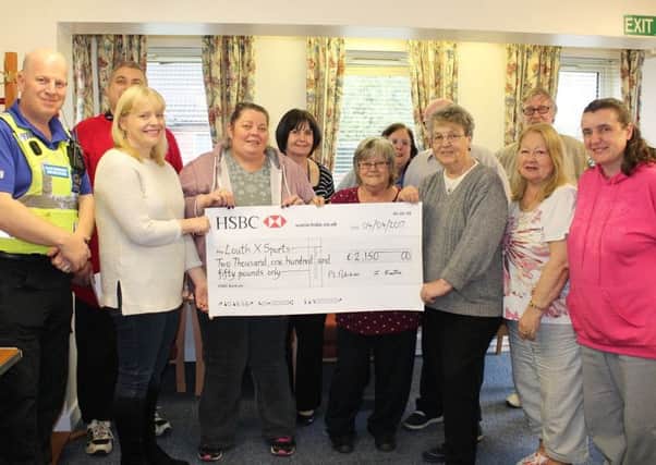 Beech Grove Residents' Association presents the cheque to Yvonne Andrews and Sarah Dodds from LouthXSports.