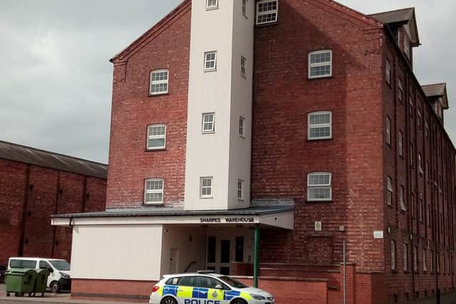 A police car remains parked outside Sharpes Warehouse in Sleaford, where officers and ambulance crews attended in the early hours due to concerns for a man barricaded in. EMN-170704-151204001