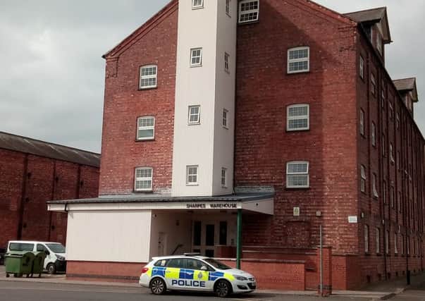 A police car remains parked outside Sharpes Warehouse in Sleaford, where officers and ambulance crews attended in the early hours due to concerns for a man barricaded in. EMN-170704-151204001
