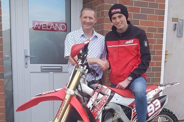 Trophy-laden Jack is presented with a new exhaust by Jason Palmer at Aveland Electricals new offices EMN-171004-123343002