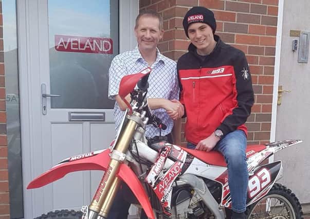 Trophy-laden Jack is presented with a new exhaust by Jason Palmer at Aveland Electricals new offices EMN-171004-123343002