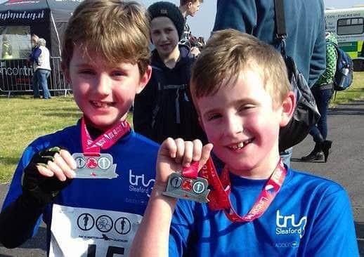 Ted Bentley and Oliver Higgins show off their medals at the RAF Scampton Duathlon EMN-171004-133917002