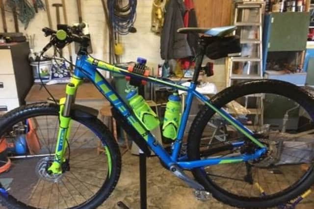 The blue and green coloured cube bike that was taken.