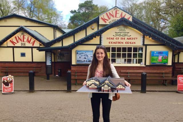 Holly Parkinson is pictured holding her Kinema In The Woods architectural model, in front of the venue itself. EMN-170417-154720001