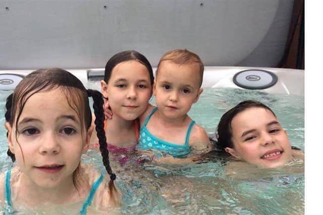 Top of the class: The Ball sisters relax after their amazing performance in the Swimathon at Horncastle swimming pool. Photo supplied.