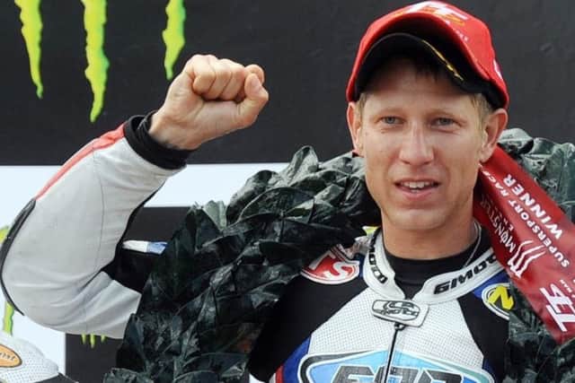 Johnson on the TT podium in 2011 after winning the Supersport race EMN-170413-112012002