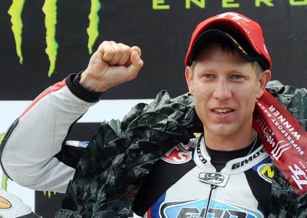 Johnson on the TT podium in 2011 after winning the Supersport race EMN-170413-112012002