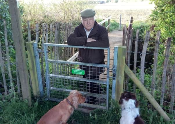 Ged Houlton is urging walkers in North Willingham to take care when using the footpath which runs through his six acre paddock. He is pictured  with his Cocker and Springer spaniels. EMN-170427-112901001