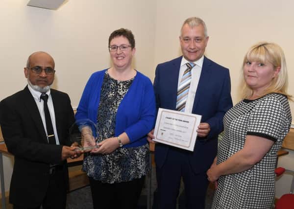 Sleaford Town Awards 2017. Sleaford Mid Lincs Citizens Advice team win the Charity of the Year Award sponsored by the India Garden, presented by proprietor Nadim Aziz. EMN-170424-100417001