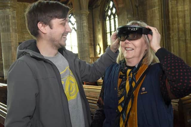 Heckington parish church hosting a special exhibition. Paul Canning showing Marilyn Scholefield his vitual reality goggles. EMN-170105-142021001