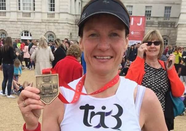 Tri3 Sleaford Triathlon Club member Kerri Shore with her London Marathon medal EMN-170428-161005002