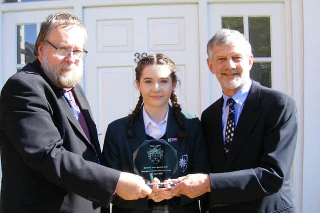 Fiona Lucas receives her Junior Sports Individual Award from Mayor of Sleaford Coun David Suiter and sponsor Clive Wicks. EMN-170805-172348001