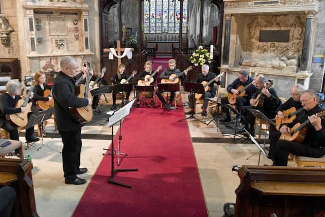 Solo Classical Guitar Ensemble playing a charity gig in St Denys Church. EMN-170805-160636001