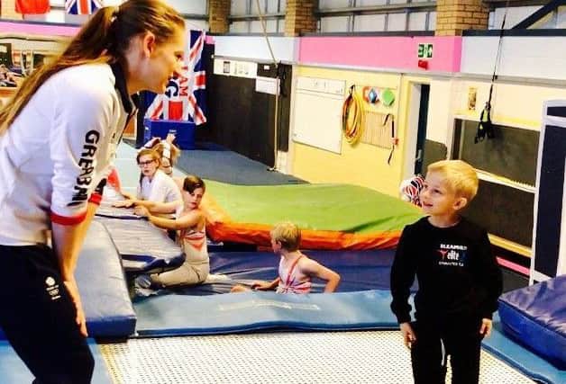Bryony gives a few coaching tips to young trampolinist Teddy Shields EMN-170405-115320002