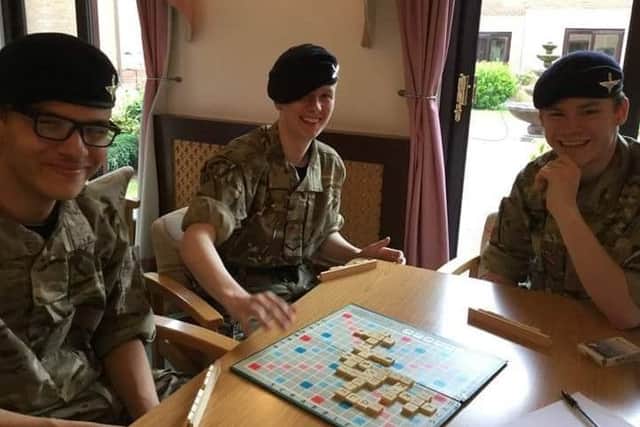 Cadets enjoying a game of Scrabble at Tanglewood Care Home EMN-170514-203026001