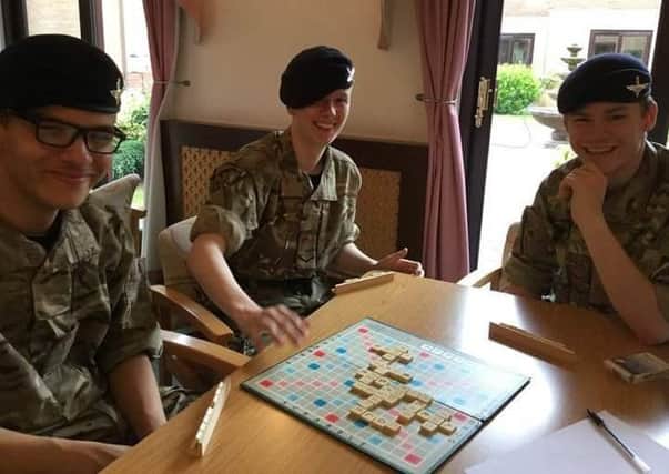 Cadets enjoying a game of Scrabble at Tanglewood Care Home EMN-170514-203026001