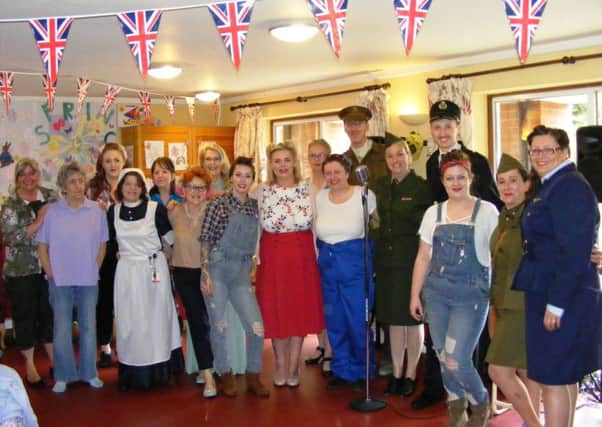 Singer Tara Stafford-Allen is joined in the 1940s theme by staff and relatives at Ashdene Care Home in Sleaford for VE Day. EMN-170515-180749001