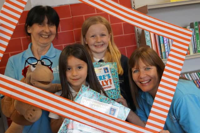 Library staff Pat Forester and Mel Fenwick with Wher's Wally? winners Momo Chambers and Emma Eckersley EMN-170516-153412001