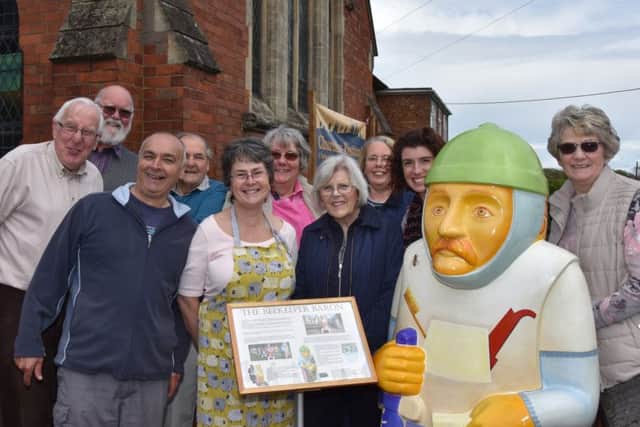 Helpers and visitors stand with Beekeeper Baron at Wragby Methodist Church during the open weekend EMN-170522-094653001