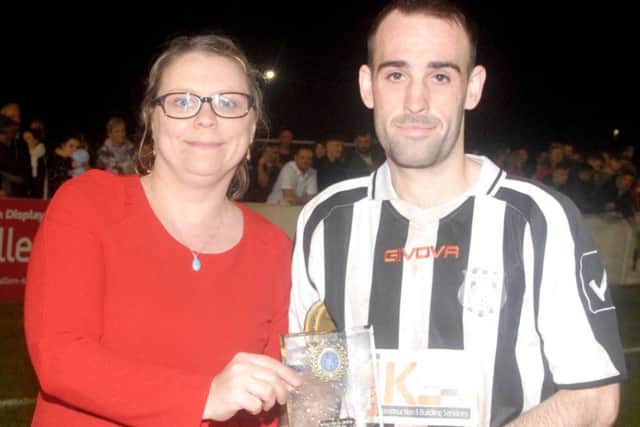 Brigg's Adam Gowing receives his man-of-the-match award from Maria Elliott of Lincolnshire League sponsors Balcan Lighting Supplies. EMN-170515-121451002