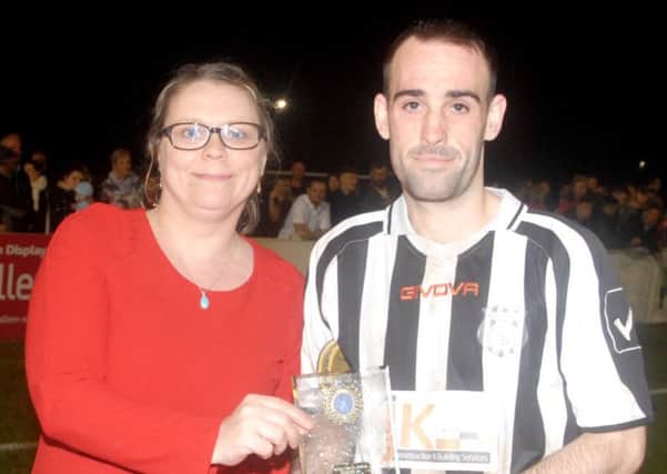 Brigg's Adam Gowing receives his man-of-the-match award from Maria Elliott of Lincolnshire League sponsors Balcan Lighting Supplies. EMN-170515-121451002