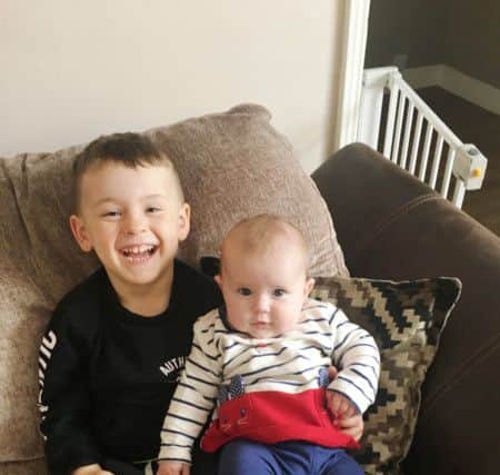 A healthy, happy Teddie with his baby sister, Ellie.