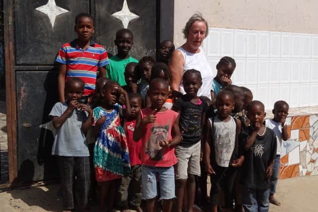 Leasingham School bursar and governor Christine Trevithick with some of the 3,000 pupils that attend the Bakoteh Annex Lower Basic School in The Gambia during her visit. EMN-170519-155733001