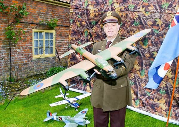 Phil Cooling of Skegness in a USAF uniform with a model Lancaster at the 40's event at the Village Church Farm in Skegness. ANL-170522-131717001