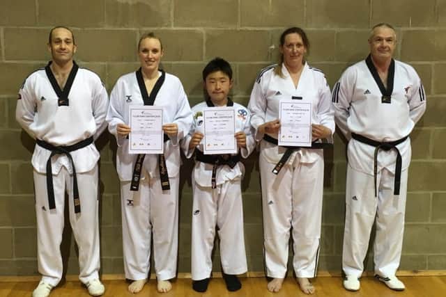 From left, instructor Ian Ball with black belt trio Rosemary Metcalfe, Micheal Subberwal and Leanne Gowler and instructor Tom Ball EMN-170518-164412002