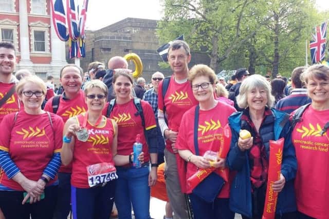 Karen Needham at the end of the race with her medal and the family and friends who travelled to London to support her on the day.