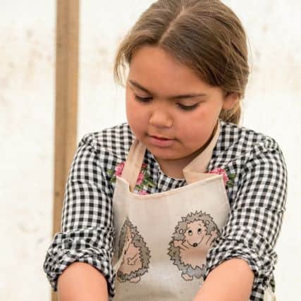 Elise Kay age 8 making a clay pot EMN-170522-065212001