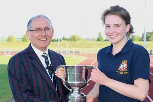 Cadet Corporal Ella Hansford accepts the Championship Trophy from Wing Commander Tony Wright, Officer Commanding Trent Wing ATC EMN-170522-173730002