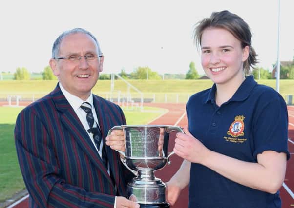 Cadet Corporal Ella Hansford accepts the Championship Trophy from Wing Commander Tony Wright, Officer Commanding Trent Wing ATC EMN-170522-173730002