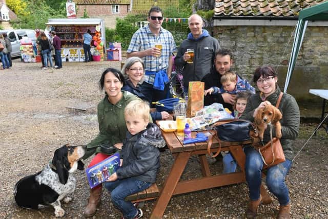 Newton village fete. L-R Flynn Barwell 5, Linzi Barwell with dog Mungo, Natalie Hibbitt, Russ Hibbitt, Lee Andrews, Ed Barwell, Henry Andrews 4, Evie Andrews 3, Justine Sherwood with puppy Winston. EMN-170522-103838001