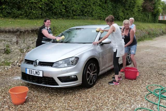 Jess Garner, Patricia Connor, Hulda Whitehead and Angie Thomas cleaning one of the cars. (Lin) EMN-170530-152925001