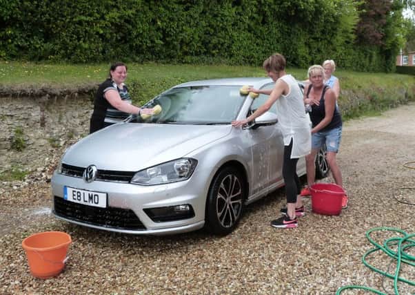 Jess Garner, Patricia Connor, Hulda Whitehead and Angie Thomas cleaning one of the cars. (Lin) EMN-170530-152925001