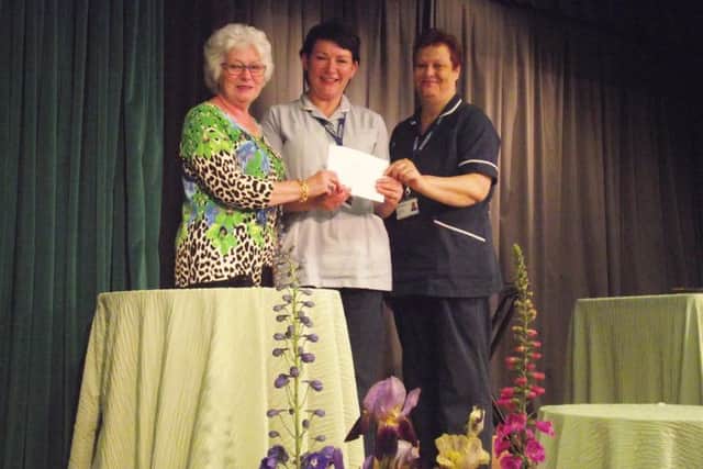 Retiring Chairman Kathy Fairburn presented St Barnabas Nurses Boston with a cheque for ?1000, a charity close to her heart,as they helped care for her late husband Jim. EMN-170206-085822001