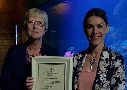 Elisabeth Wright and Louise Chapman holding the TED Age Friendly Business Award presented to Skegness Aquarium. EMN-170806-162952001
