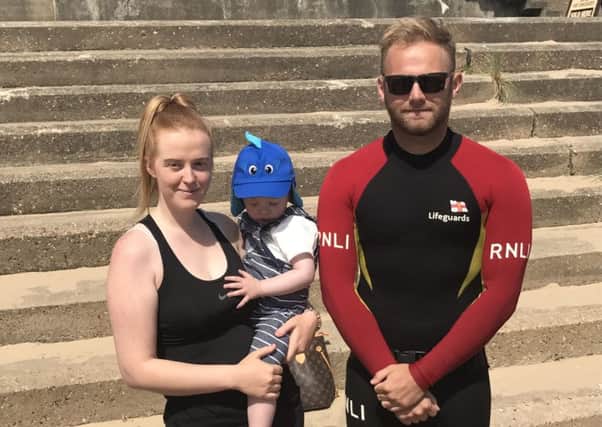 Mum Nicole Manderson with son Jenson, (one), pictured with Tom Robert,  just one of the two lifeguards that came to their aid.