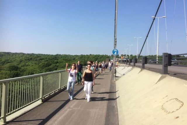 Walking across the Humber Bridge. EMN-170506-101753001