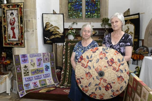 Vibrant colours fill St Denis' Church at Silk WIlloughby at their Quilt and Flower festival. Janet Johnson, left and Sue Logan
Picture: Sarah Washbourn / www.yellowbellyphotos.com EMN-170506-143858001