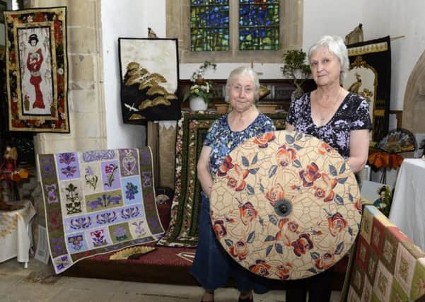 Vibrant colours fill St Denis' Church at Silk WIlloughby at their Quilt and Flower festival. Janet Johnson, left and Sue Logan
Picture: Sarah Washbourn / www.yellowbellyphotos.com EMN-170506-143858001