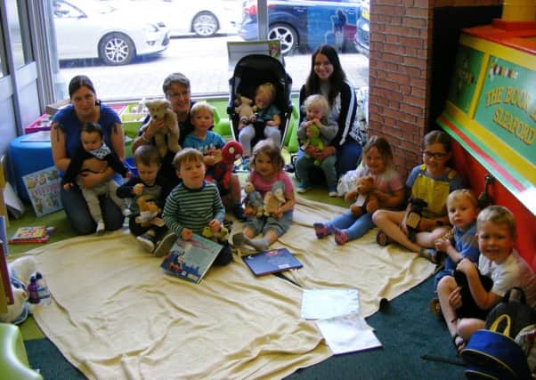 Youngsters, parents and Sleaford Library staff enjoy their teddy bears' picnic. EMN-170613-115525001