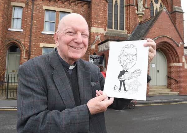 Father Michael Bell leaving Sleaford's Our Lady of Good Councel. Pictured with his caricature that was in the Sleaford Standard.