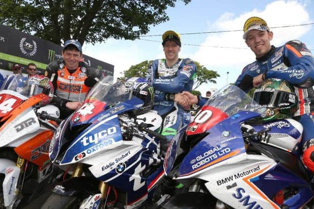 Peter Hickman (right) in the winners enclosure at the Superstock race with Martin Jessopp (left) and Michael Rutter EMN-170806-111923002
