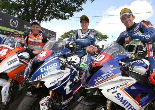 Peter Hickman (right) in the winners enclosure at the Superstock race with Martin Jessopp (left) and Michael Rutter EMN-170806-111923002