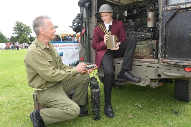 1940's event at Central Park, Boston. Anthony Freeman of Woodhall Spa demonstrating morse code to Matthew Lewis 11 of Boston. EMN-171206-123652001