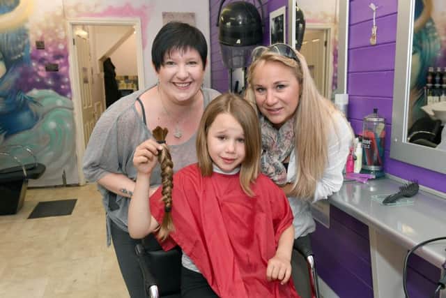 Hairdresser Emma Bailey with Rosie-Mai and her mother Nicola Manger after having her hair cut. EMN-170613-102321001
