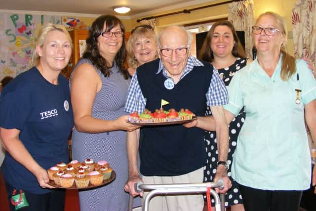 Celebrating Cupcake Day for the Alzheimer's Society and National Care Home Open Day, from left Tesco community volunteer Lesley Sargeant, Ashdene Care Home manager Jilly Hunt, activity volunteer Susanne Williams, resident Hugh Burbidge celebrating his 99th birthday, singer Tina Wynters and care home staff member Dorinda Hawkins. EMN-170616-155323001